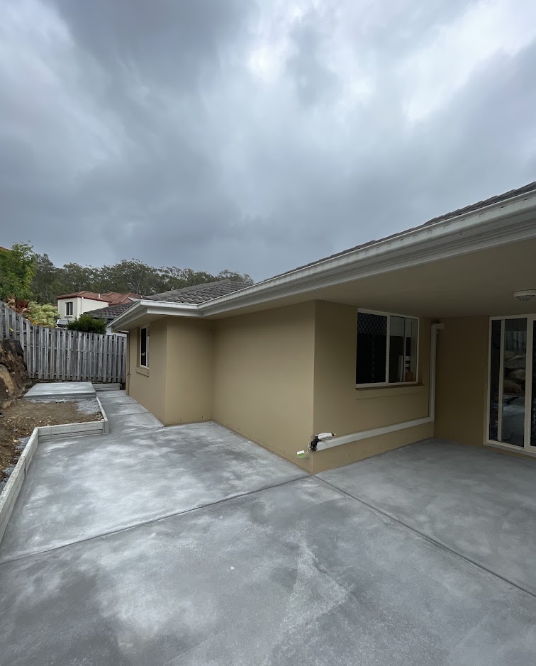 Same backyard finished with a wide concrete slab